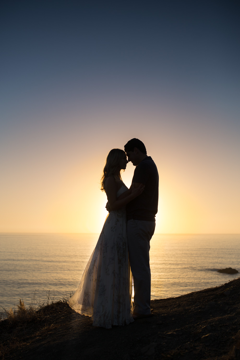 silhouette engagement portrait up on a cliff at pacifica state beach