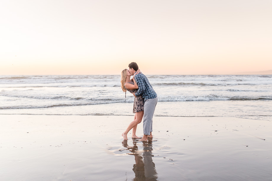 san francisco beach engagement photo - dipping on the sand under the sunset colors