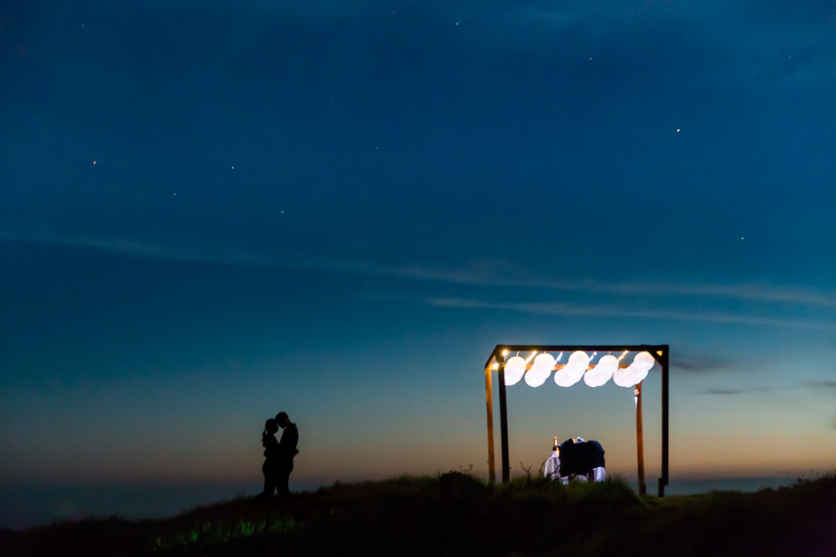 stunning private dinner setup with lanterns on a San Francisco hill overlooking the Golden Gate Bridge